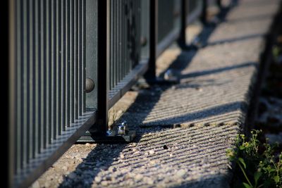 High angle view of railing on footpath