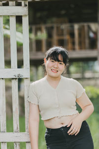 Portrait of smiling woman standing outdoors