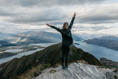 Man standing on mountain against sky