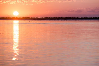 Scenic view of sea against sky at sunset