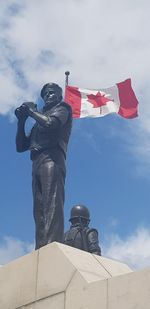 Low angle view of statue against sky