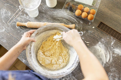 Cropped hands of person preparing food