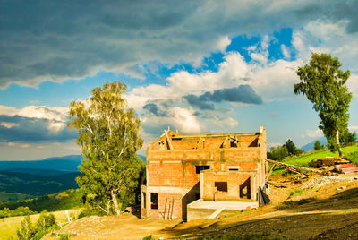 Built structure on landscape against sky