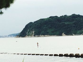 Scenic view of sea with mountain in background