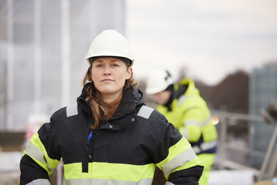 Female engineer standing at building site