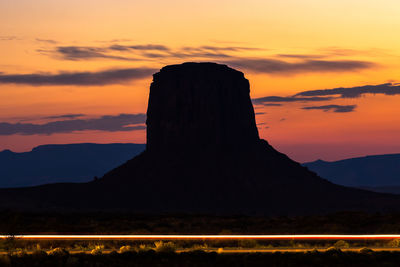 Silhouette of mountain road during sunset