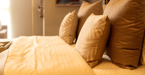 Midsection of man relaxing on bed at home