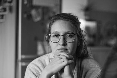 Close-up portrait of young woman at home