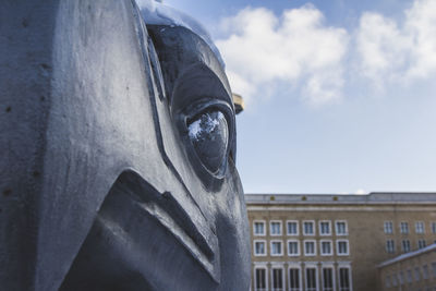 Low angle view of statue against sky in city