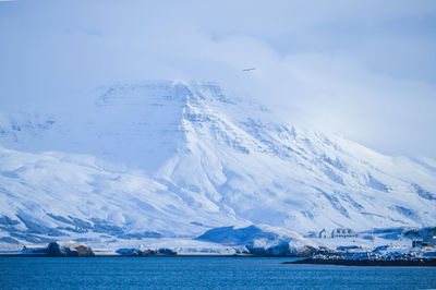 Scenic view of sea and mountains against sky