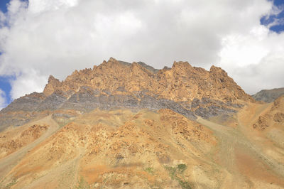 Brown rocky mountain with cloudy sky on the way of darcha-padum road, ladakh, india 