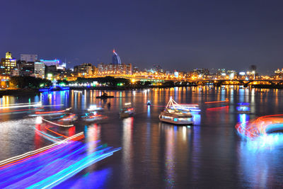 Illuminated boats moored at night