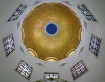 Directly below shot of ornate ceiling and building