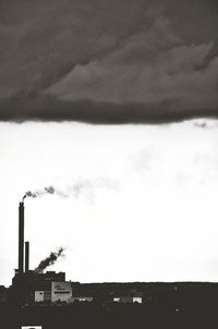 Low angle view of built structure against cloudy sky