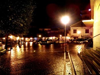 Illuminated city street at night