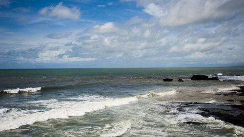 Scenic view of sea against cloudy sky