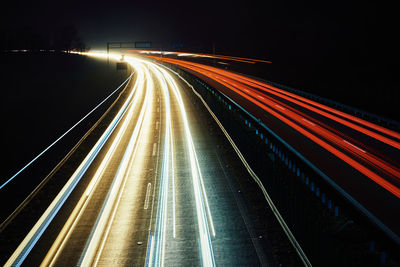 Moving car lights on highway at night, long exposure