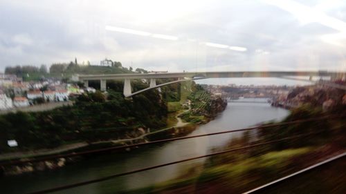 Close-up of bridge over river in city against sky