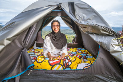 Rear view of woman in tent