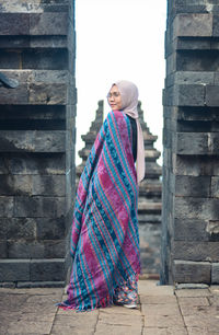 A woman with traditional weaving. cetho temple, indonesia