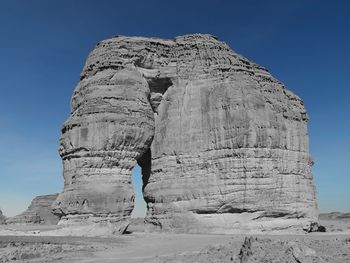 Low angle view of rock formation against sky