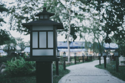 Street light by building in park