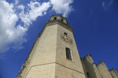 Low angle view of bell tower against blue sky