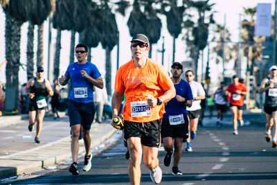 Group of people running on road