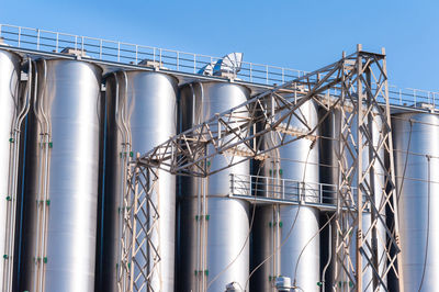 Low angle view of industry against clear sky