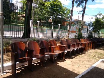 Empty chairs against trees