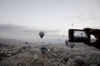 Photographer photographing through camera lens