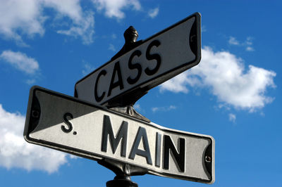 Low angle view of road sign against sky