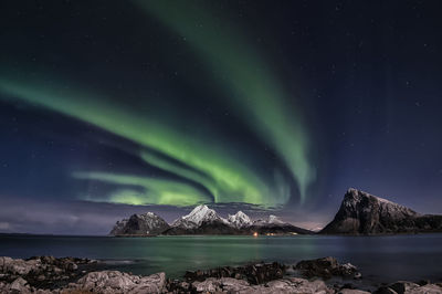 Scenic view of snowcapped mountains against sky at night