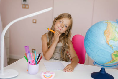 Young girl doing homework. schoolgirl at home learning