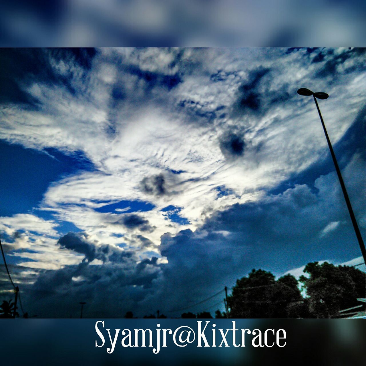 sky, communication, text, western script, cloud - sky, low angle view, cloudy, road sign, weather, information sign, sign, guidance, nature, information, cloud, arrow symbol, outdoors, day, tranquility, directional sign