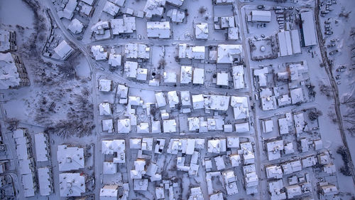 Aerial view of snow covered houses in town