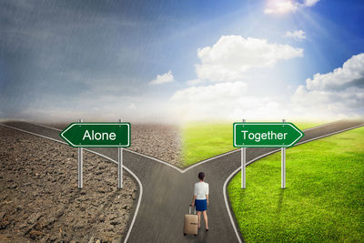 Digital composite image of woman with luggage standing amidst signs on road