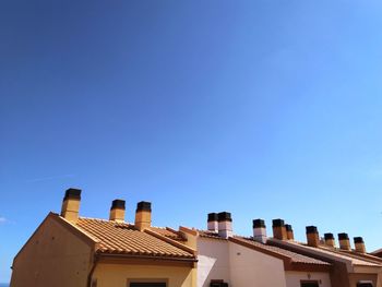 Low angle view of buildings against blue sky