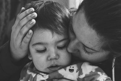 Close-up of mother kissing baby boy