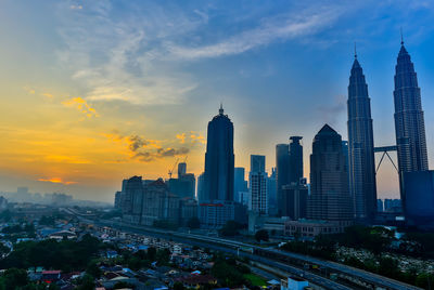 Cityscape against sky during sunset