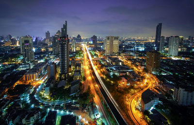 High angle view of illuminated city buildings at dusk