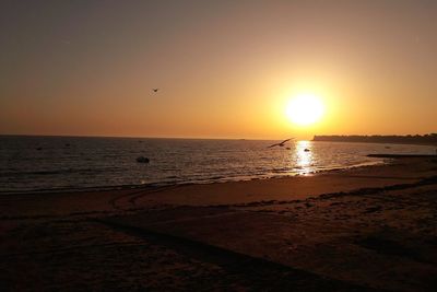 Scenic view of sea against clear sky during sunset