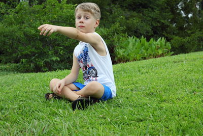 Boy sitting on field