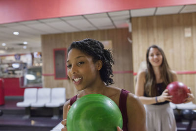 A young woman bowling.