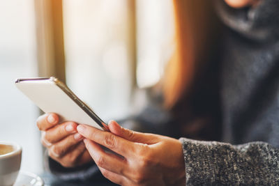 Midsection of man using mobile phone