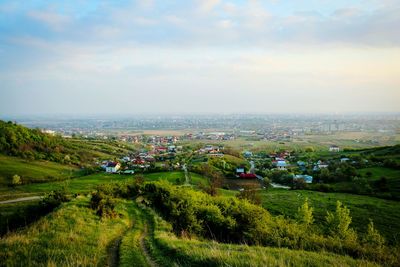 High angle view of cityscape by sea against sky