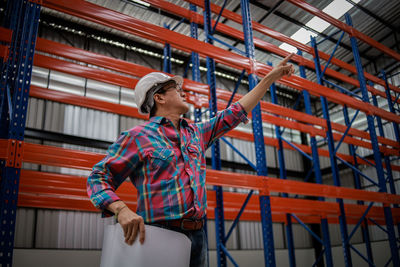 Low angle view of young woman looking away