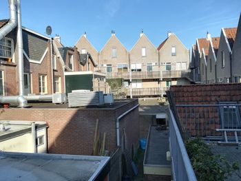 Buildings in city against blue sky