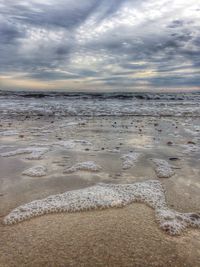 Scenic view of sea against cloudy sky