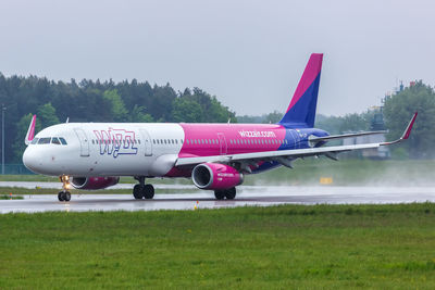 Airplane on runway against sky